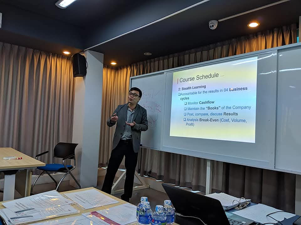 Lawrence Poh conducting a professional finance and business class
